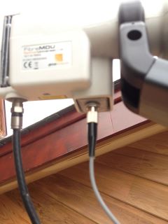 A close up of the LNB with fire optic cable